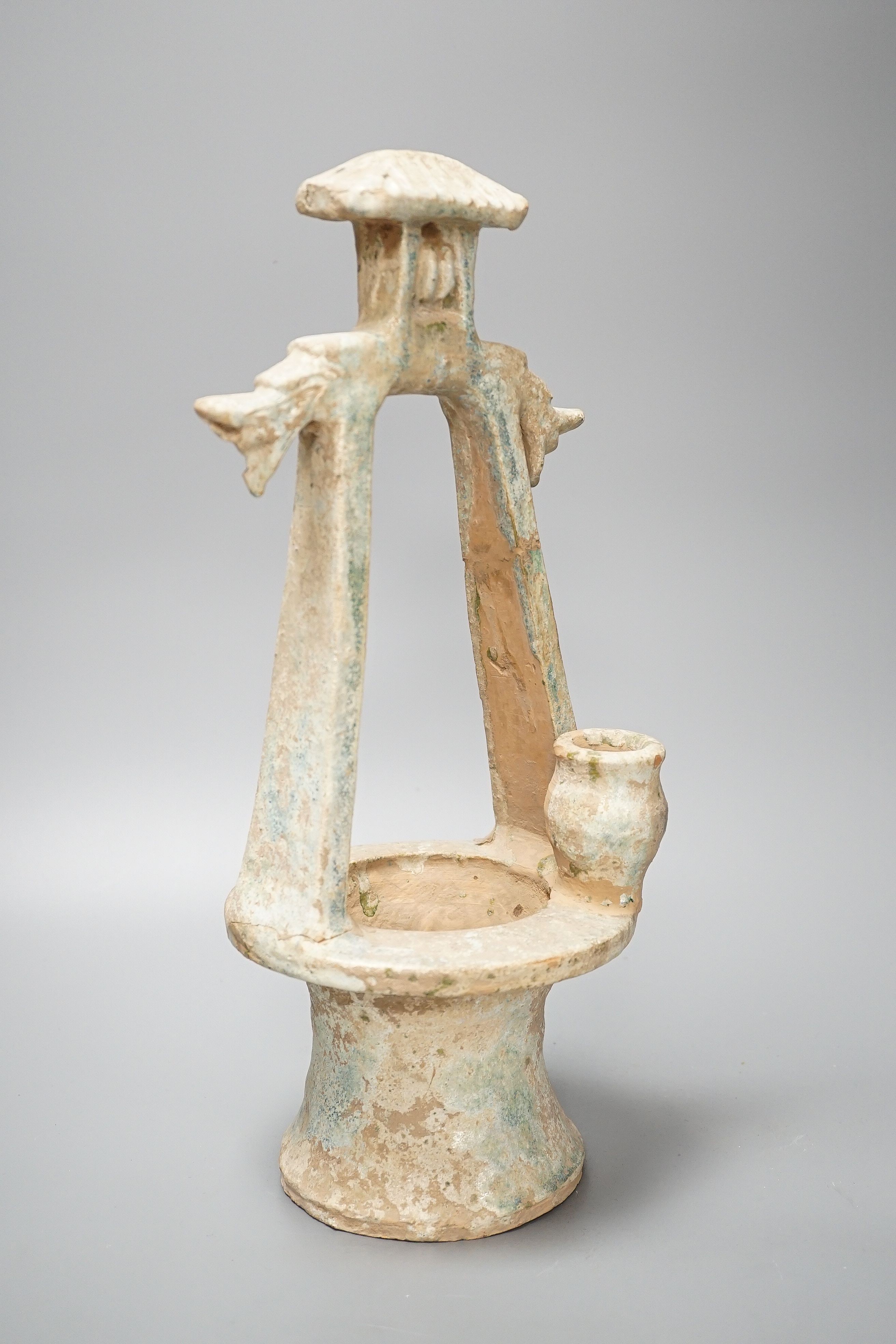 A Chinese Han dynasty green glazed model of a well, mineral iridescence to glaze, height 37cm